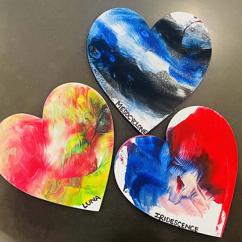 three heart paintings that dogs created