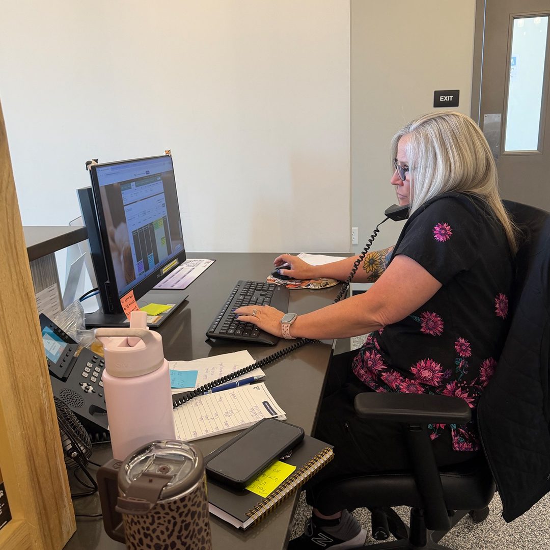 Blond Receptionist On Phone Confirming Appointment